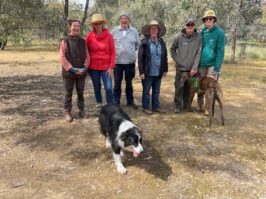 Group of landholders and two dogs who met at a field day in Nardoo. {{brizy_dc_image_alt entityId=